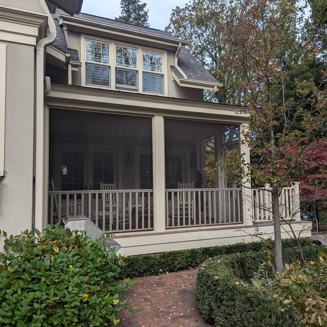 Finished backyard living space with a wood deck, railing and covered extension